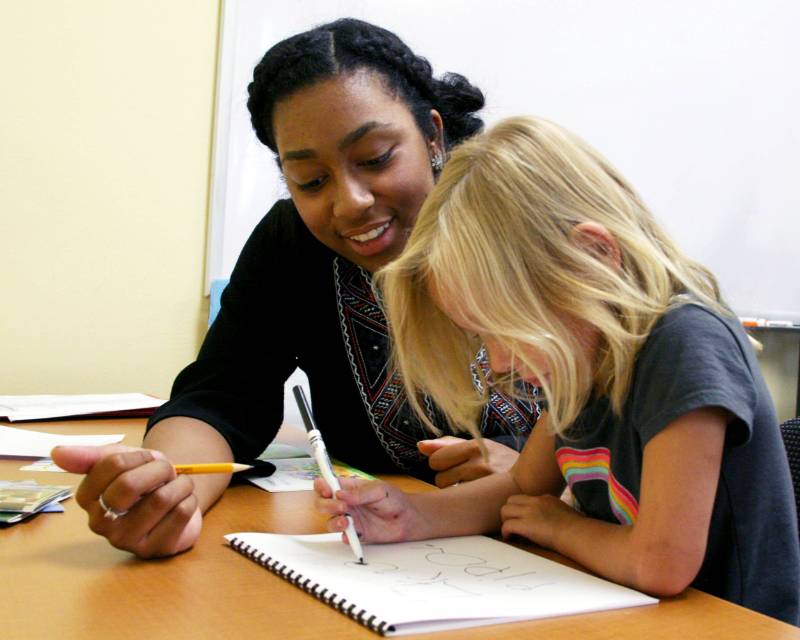 实习教师帮助幼儿学习。